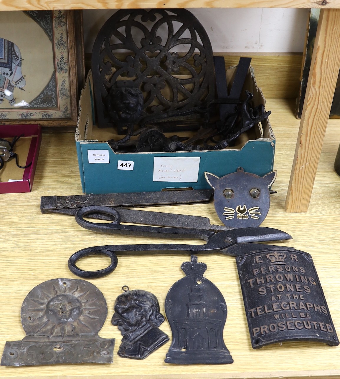 A mixed collection of iron mounts, dial elements, a trap, two fire marks etc